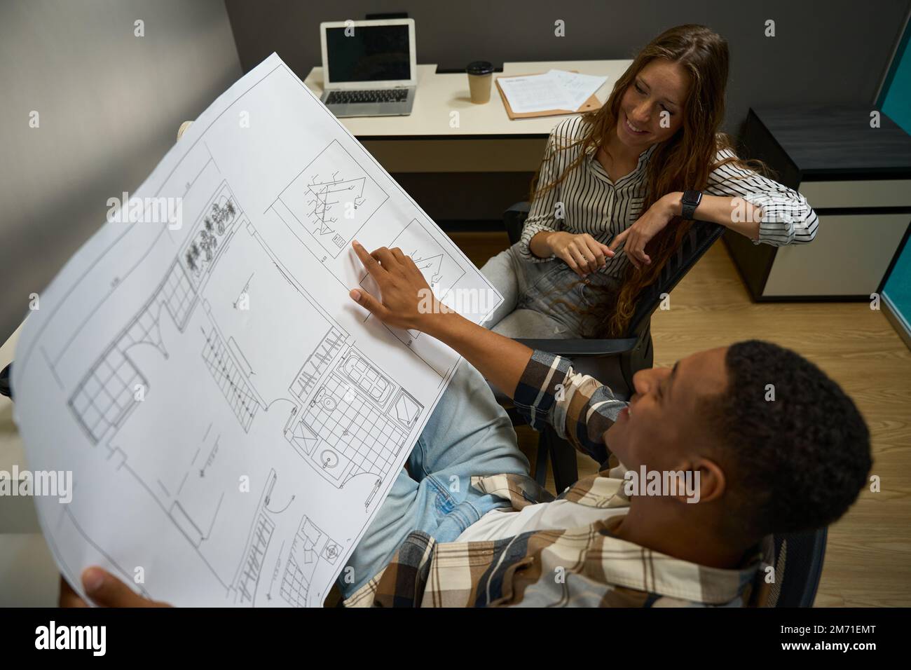 Two colleagues looking at drawing discussing a new project Stock Photo