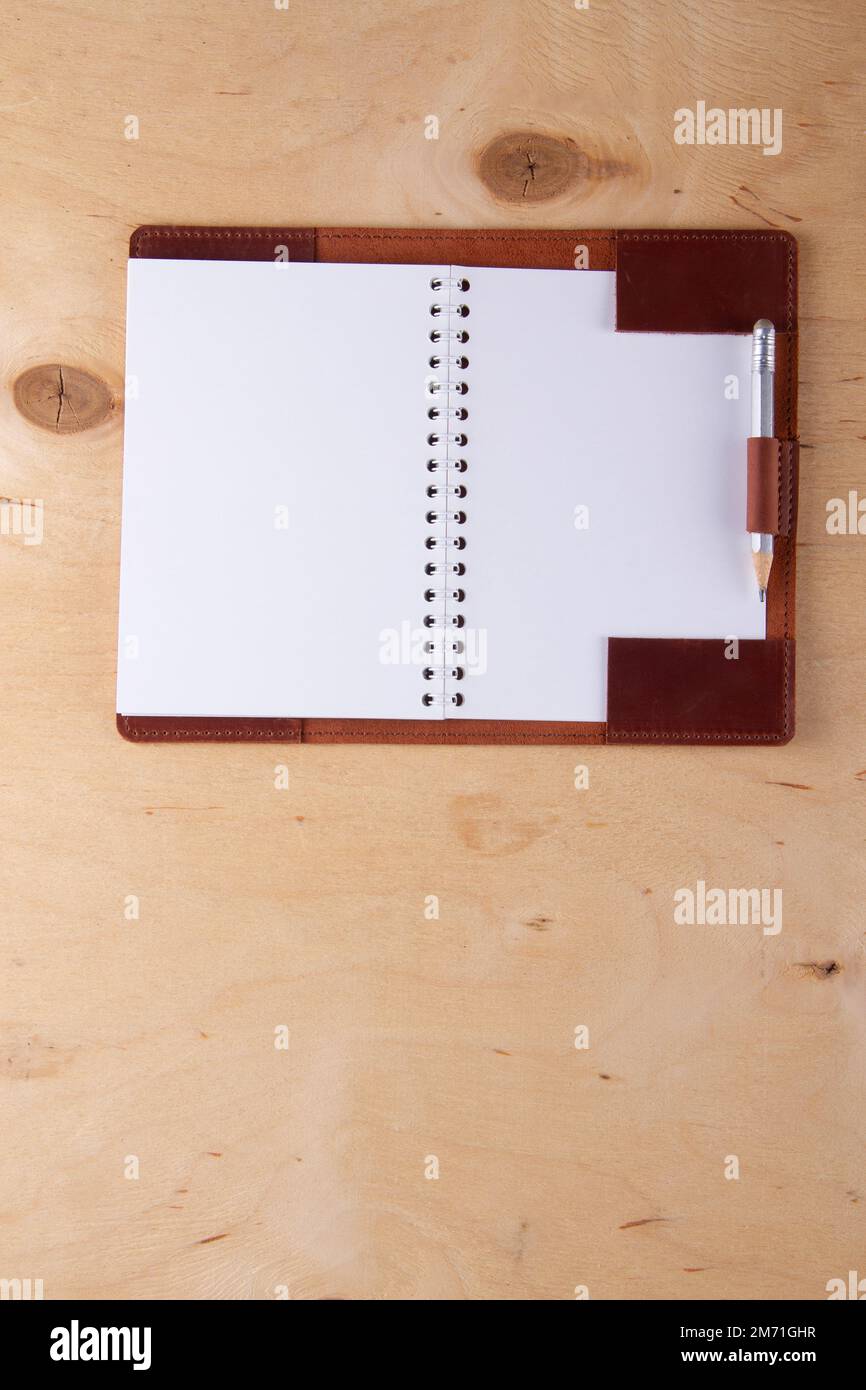 Blank notepad in leather cover with graphite pencil lie on wooden desk ...
