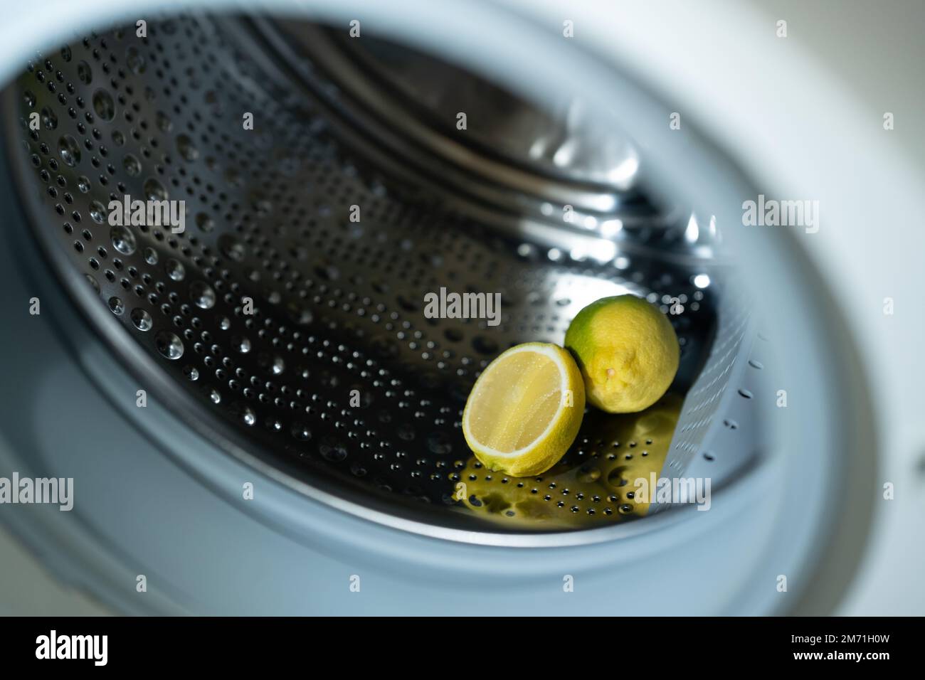 lemon inside washing machine. Half a lemon is placed on top of a whole