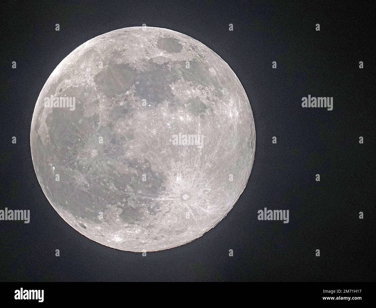 Sheerness, Kent, UK. 6th Jan, 2023. UK Weather: the full 'Wolf' moon seen through cloud cover above Sheerness in Kent this evening. Credit: James Bell/Alamy Live News Stock Photo