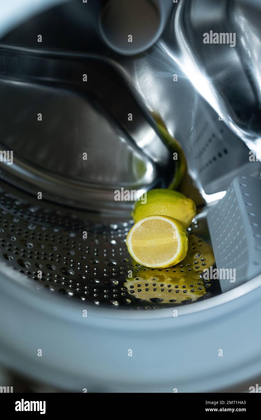 lemon inside washing machine. Half a lemon is placed on top of a whole