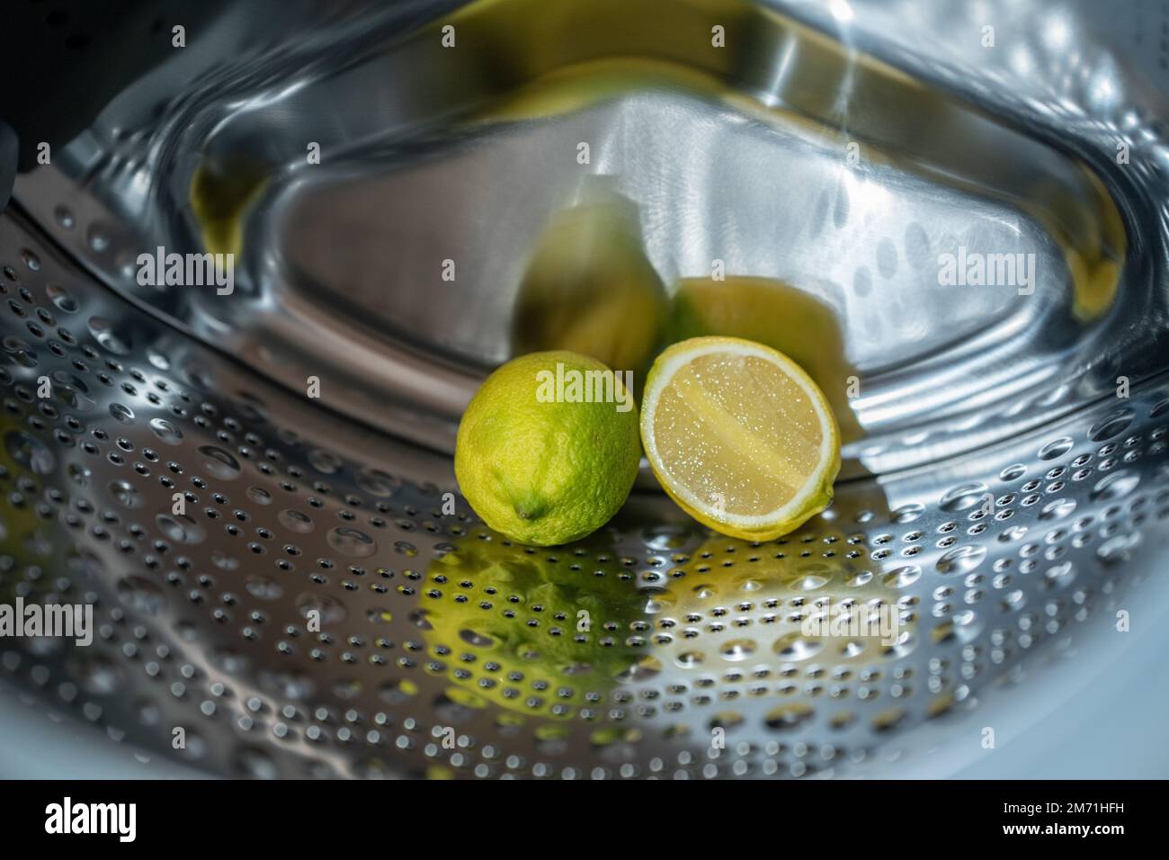 lemon inside washing machine. Half a lemon is placed on top of a whole