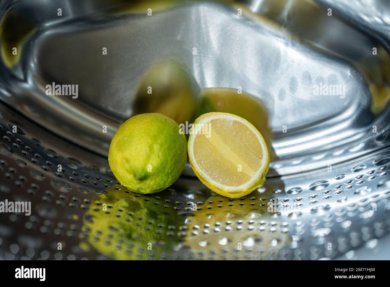 lemon inside washing machine. Half a lemon is placed on top of a whole