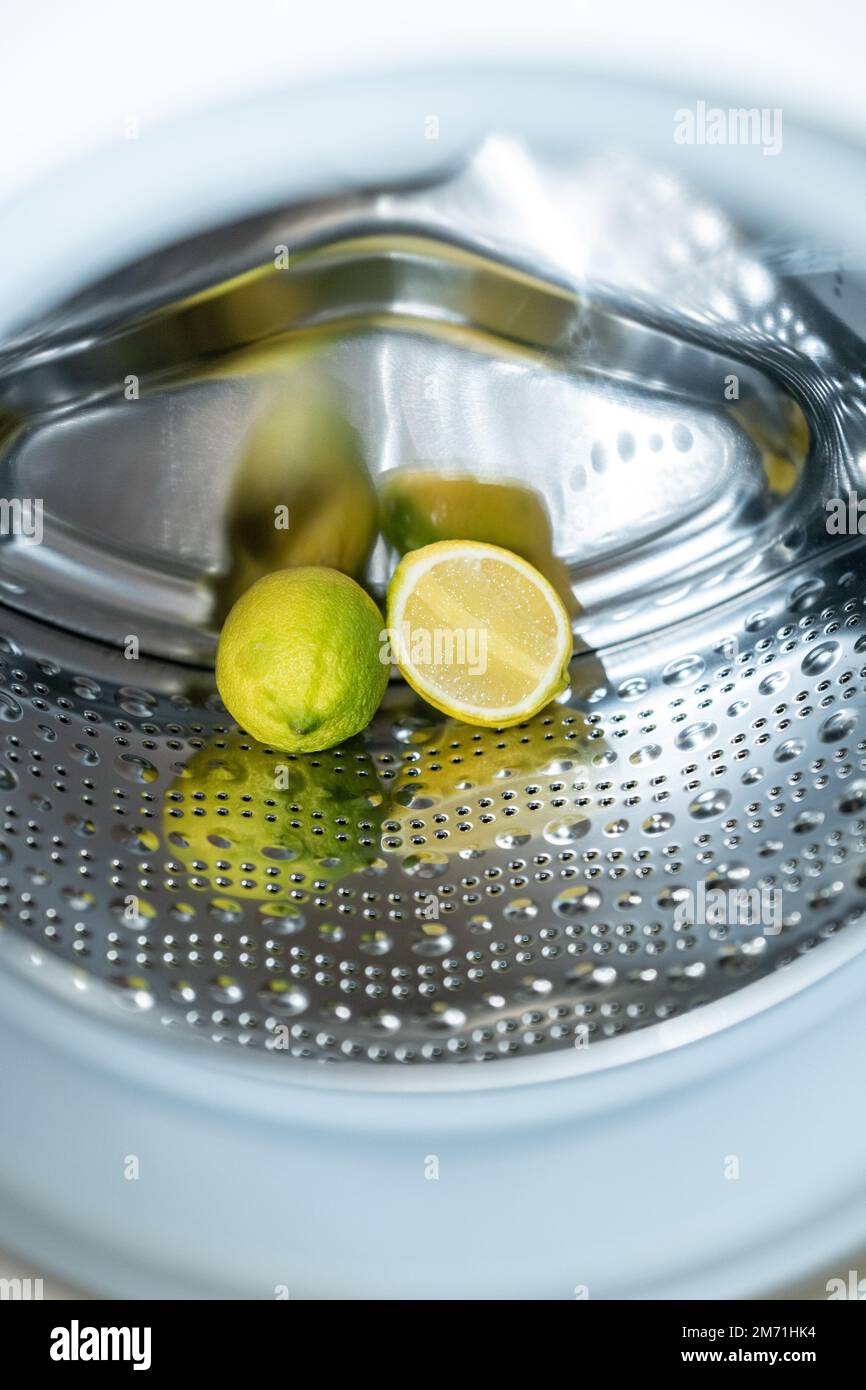 lemon inside washing machine. Half a lemon is placed on top of a whole