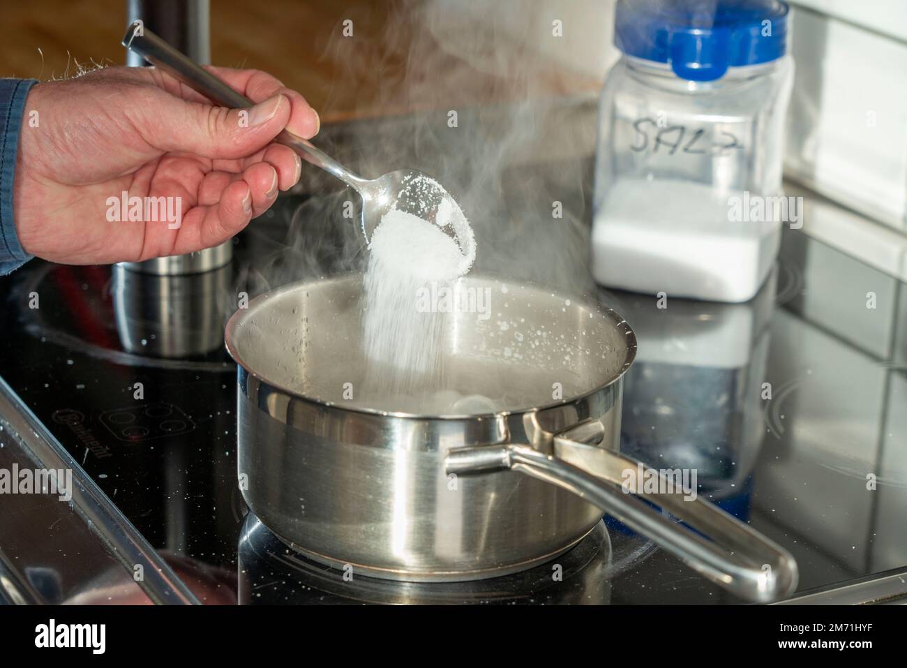 Cooking, season with salt Stock Photo Alamy