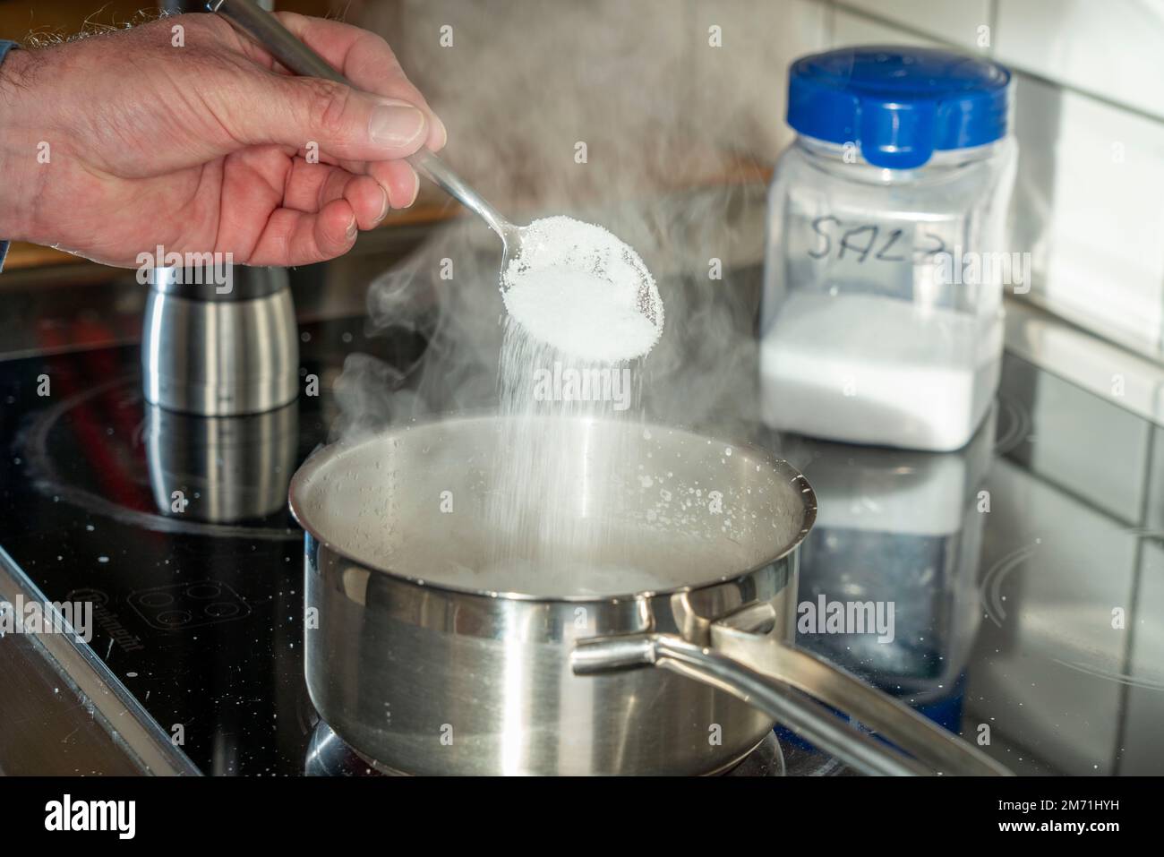Cooking, season with salt Stock Photo