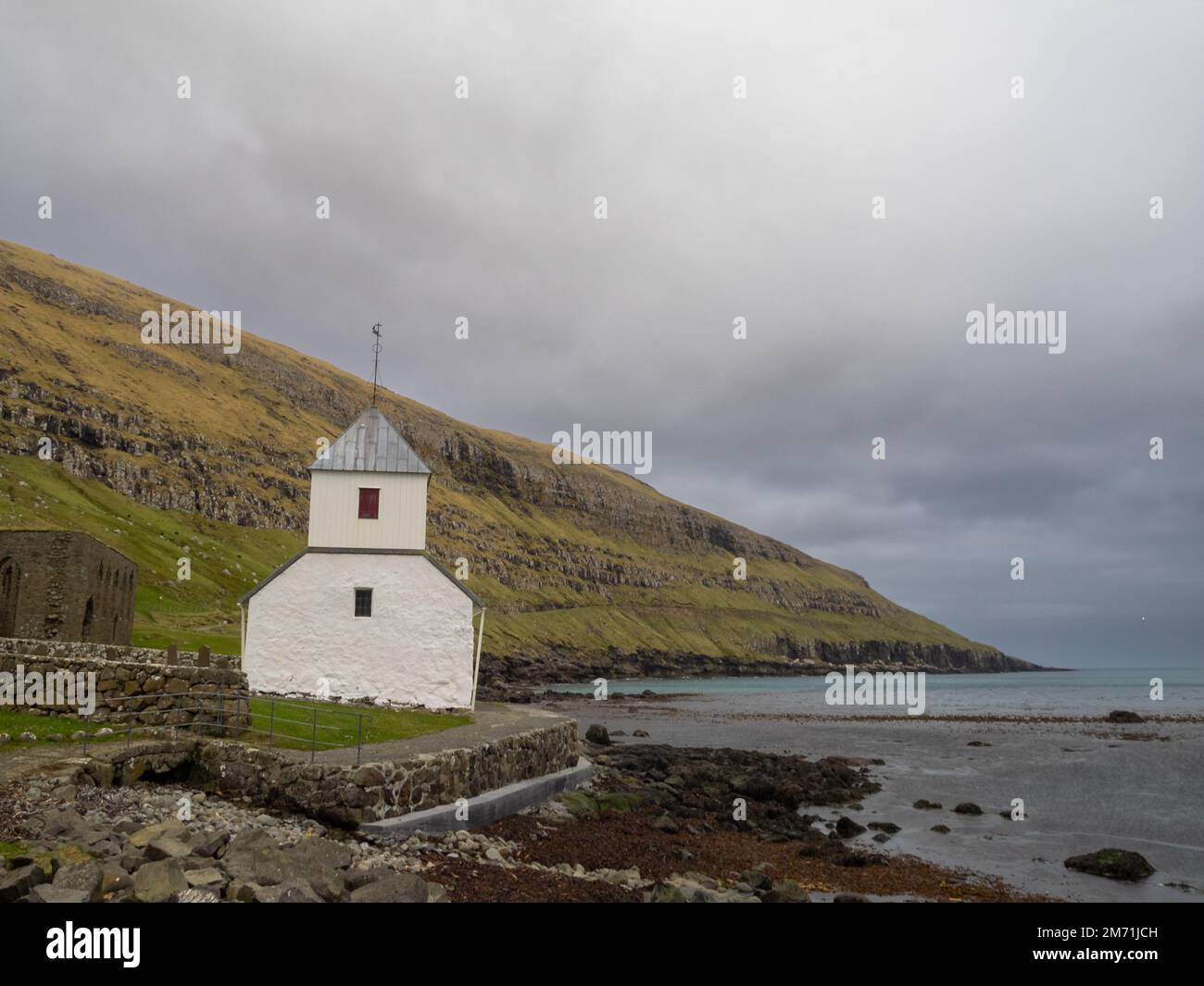 Ólavskirkjan church, the oldest in the Faroe Islands, by the seaside at Kirkjubøur Stock Photo