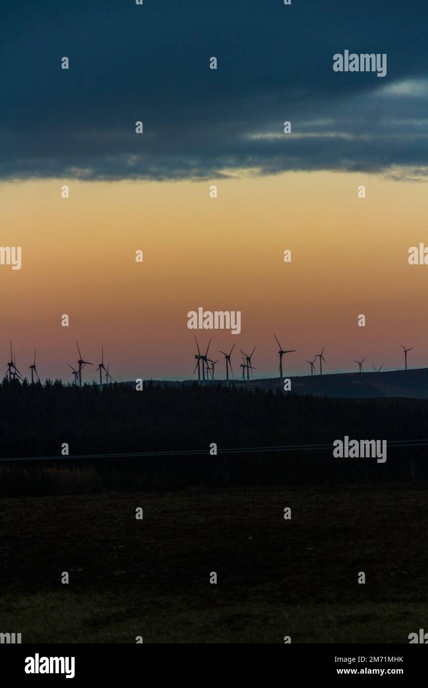 Cloud, twilight and moors, wind turbines at sunset, portrait, copyspace Stock Photo