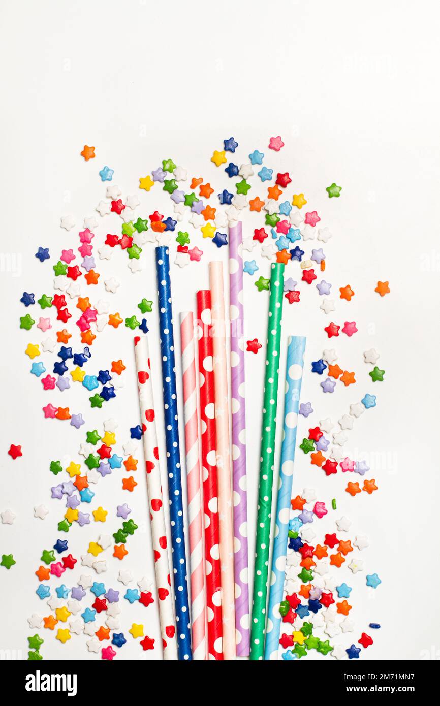https://c8.alamy.com/comp/2M71MN7/colored-with-polka-dots-drinking-straws-and-star-shape-sprinkles-on-a-white-background-with-copy-space-2M71MN7.jpg