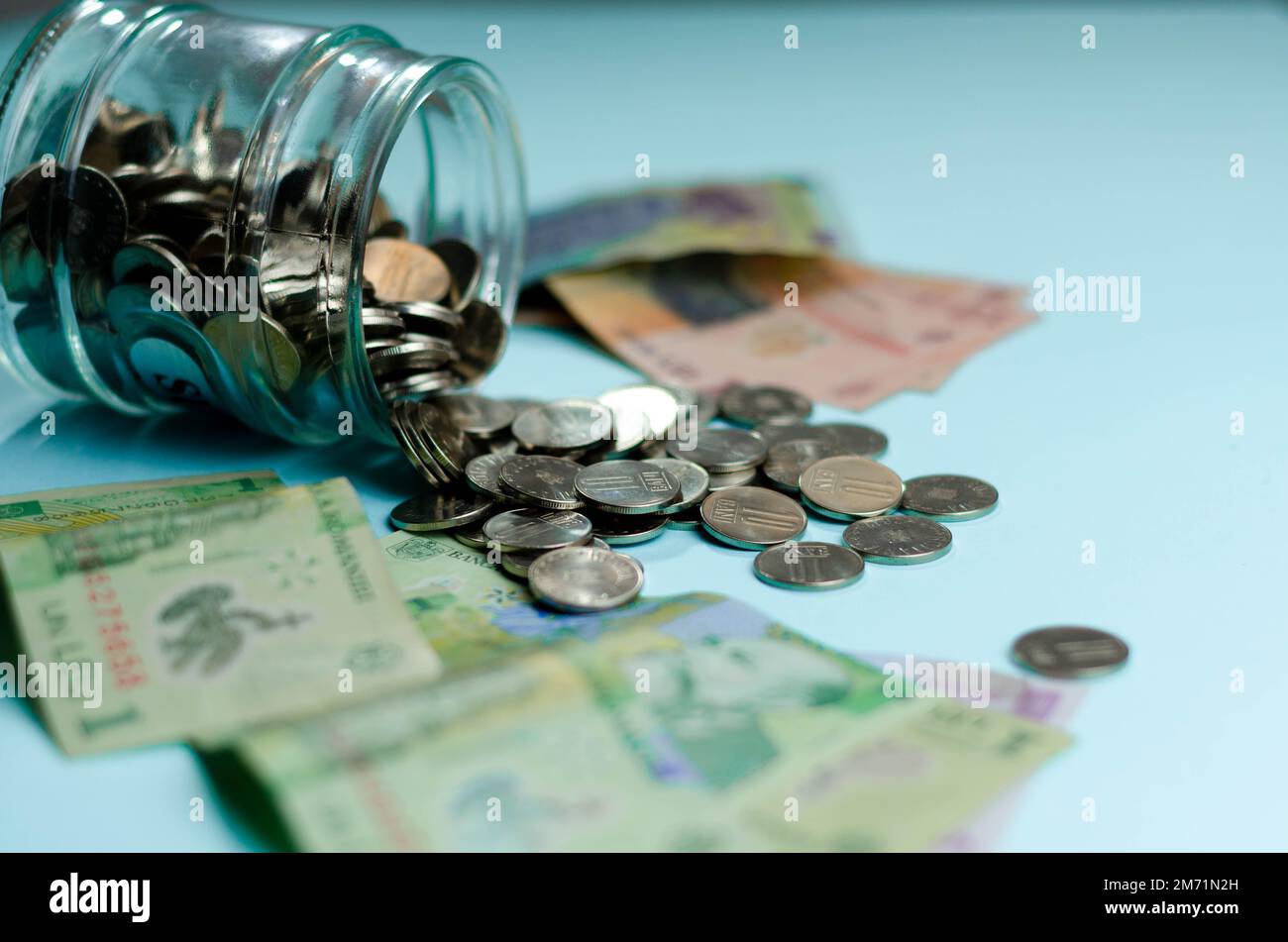 Glass jars with coins , isolated - savings concept.  Romania banknotes, Economic and financial concept, rising prices, value of Romanian leu Stock Photo