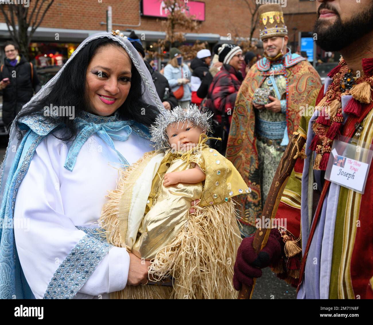 New York, USA. 6th Jan, 2023. Participants dressed up as the Virgin Mary carrying baby Jesus next to Joseph and in front of Balthasar the Wise Man march through the streets in East Harlem during the 46th annual Three Kings Day Parade organized by El Museo del Bario. The traditional Spanish celebration was held in person for the first time since the start of the coronavirus (COVID-19) pandemic. The theme for this year was: 'Entre Familia: Mental Health & Wellness of our Communities' focusing on the importance of mental health and wellness. Credit: Enrique Shore/Alamy Live News Stock Photo