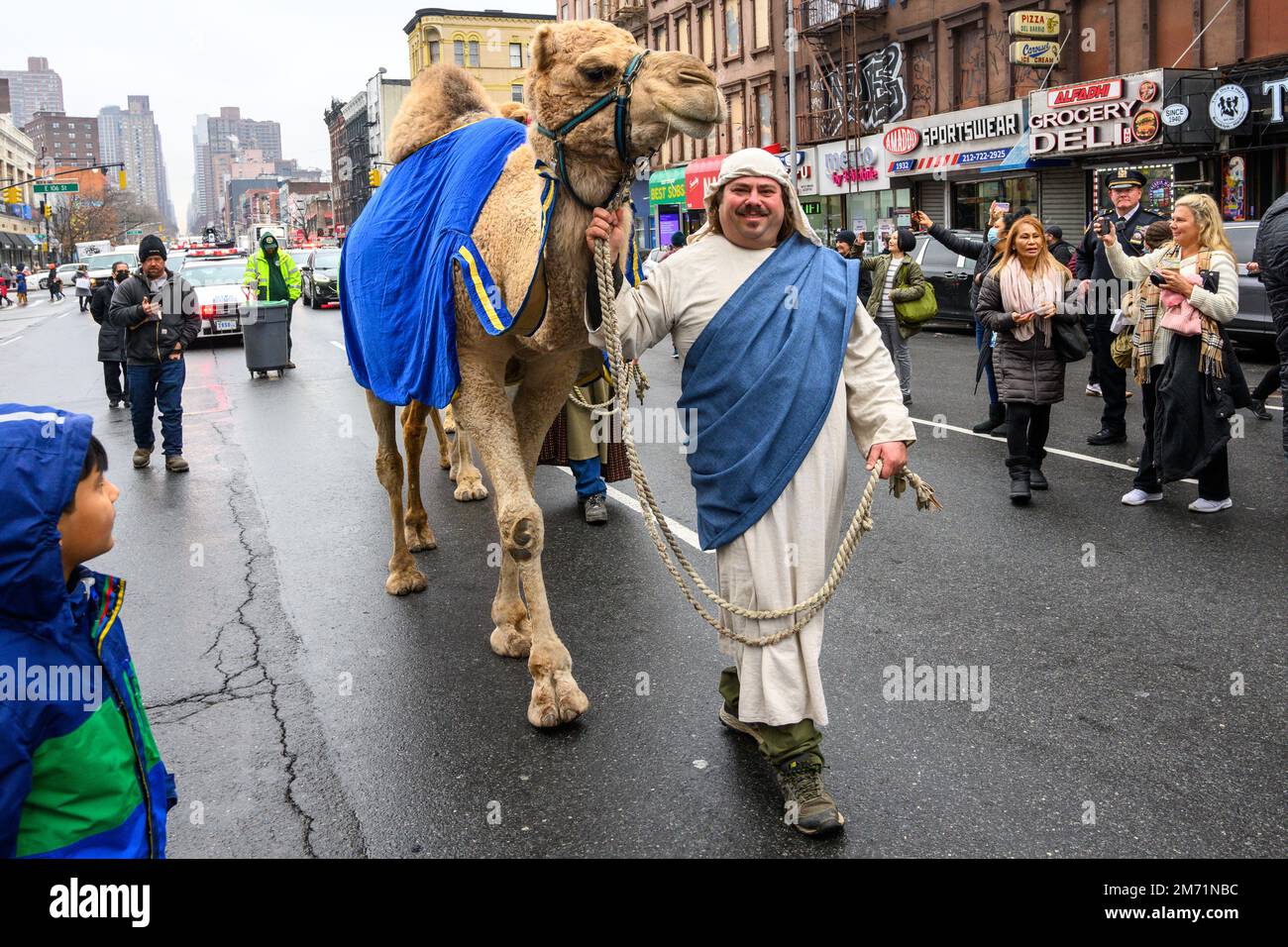 New York, USA. 6th Jan, 2023. A participant leads his camel through the streets in East Harlem during the 46th annual Three Kings Day Parade organized by El Museo del Barrio. The traditional Spanish celebration was held in person for the first time since the start of the coronavirus (COVID-19) pandemic. The theme for this year was: 'Entre Familia: Mental Health & Wellness of our Communities' focusing on the importance of mental health and wellness. Credit: Enrique Shore/Alamy Live News Stock Photo