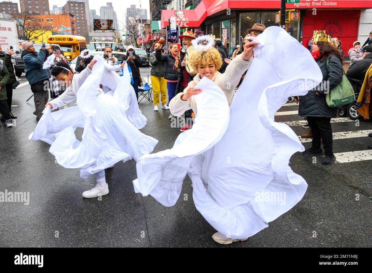 New York, USA. 6th Jan, 2023. Participants dressed up as angels perform in the streets of East Harlem during the 46th annual Three Kings Day Parade organized by El Museo del Barrio. The traditional Spanish celebration was held in person for the first time since the start of the coronavirus (COVID-19) pandemic. The theme for this year was: 'Entre Familia: Mental Health & Wellness of our Communities' focusing on the importance of mental health and wellness. Credit: Enrique Shore/Alamy Live News Stock Photo