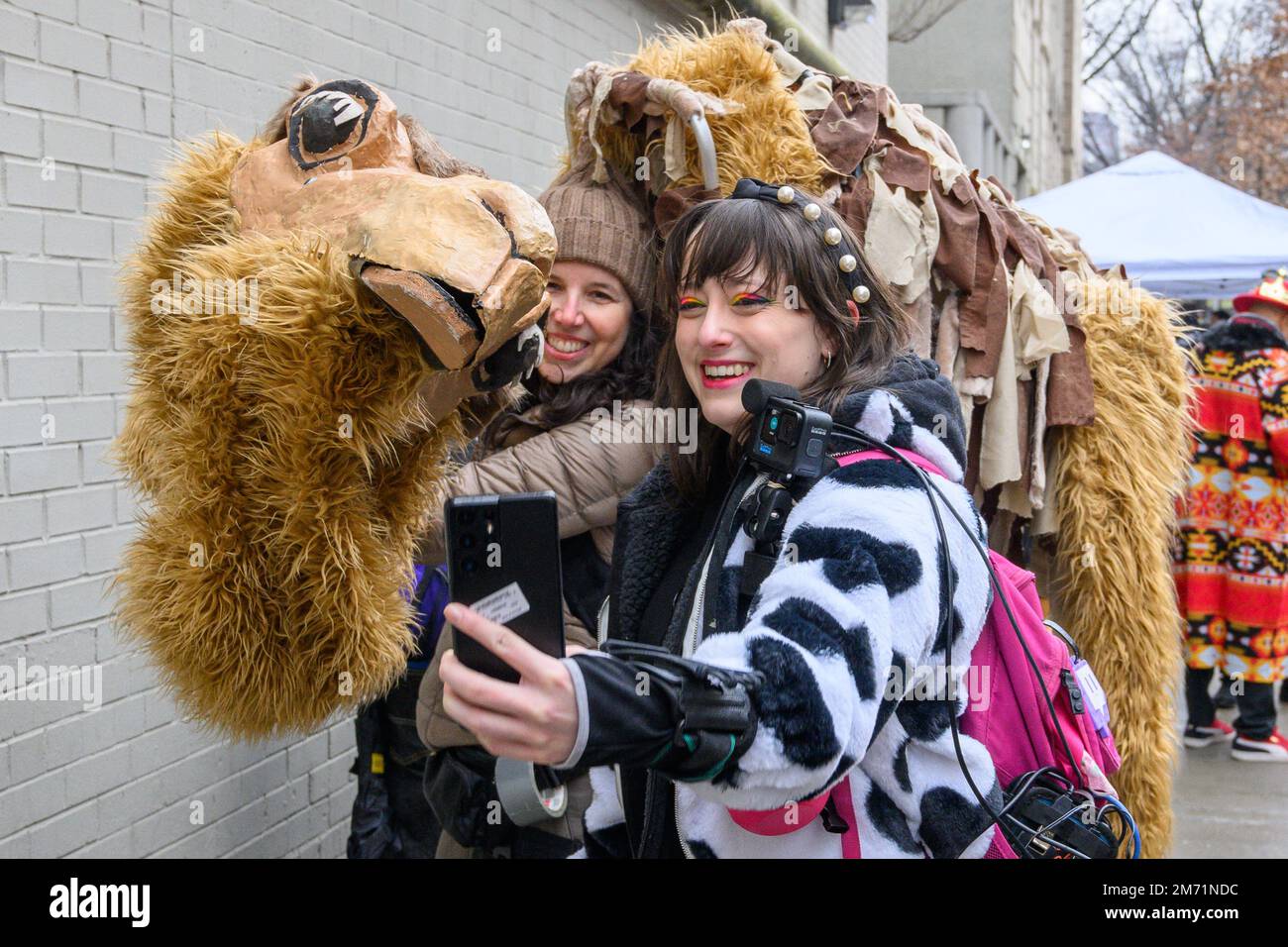 New York, USA. 6th Jan, 2023. A participant takes a selfie with a camel figure in the streets in East Harlem during the 46th annual Three Kings Day Parade organized by El Museo del Barrio. The traditional Spanish celebration was held in person for the first time since the start of the coronavirus (COVID-19) pandemic. The theme for this year was: 'Entre Familia: Mental Health & Wellness of our Communities' focusing on the importance of mental health and wellness. Credit: Enrique Shore/Alamy Live News Stock Photo