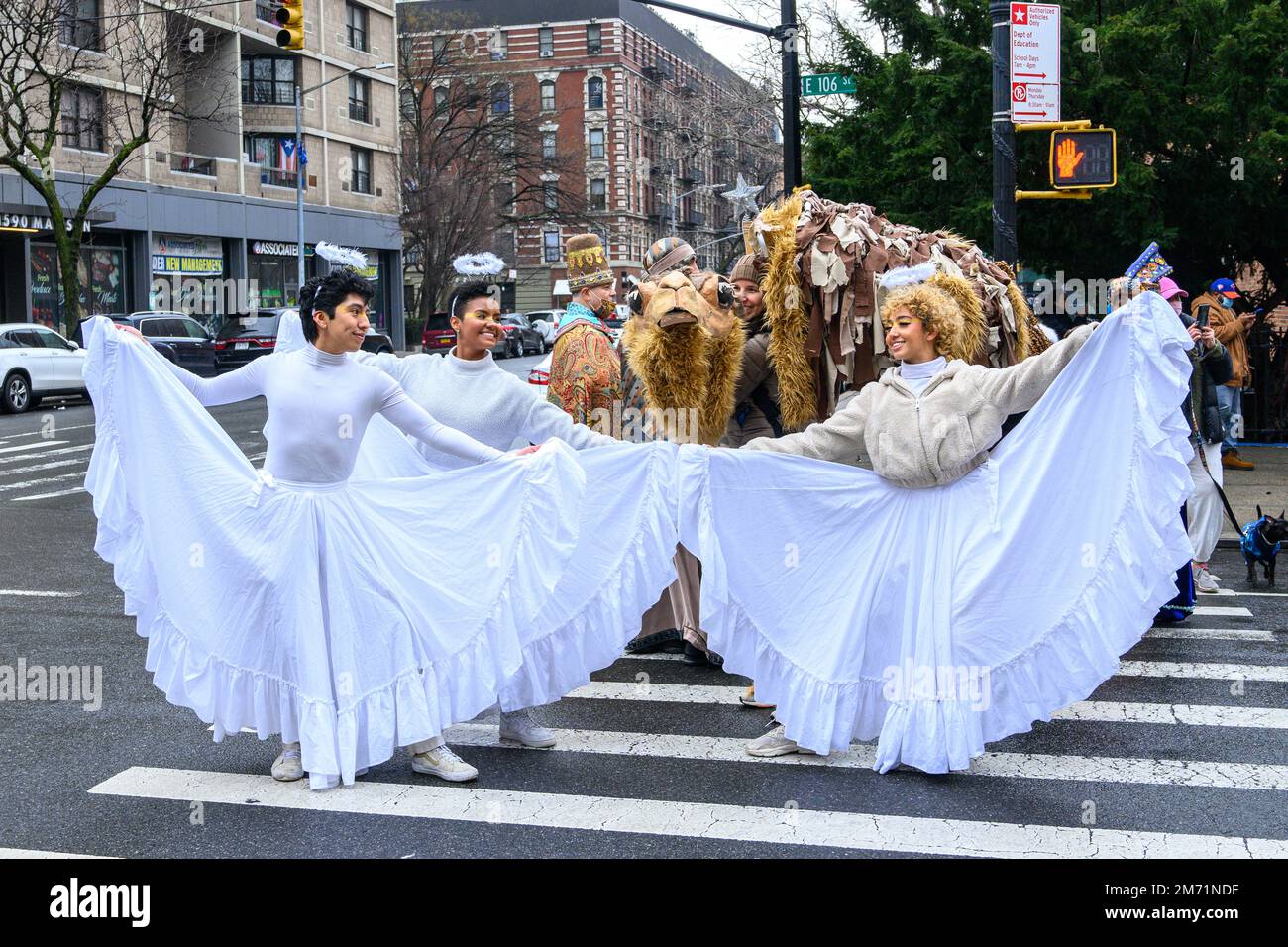 New York, USA. 6th Jan, 2023. Participants dressed up as angels have fun in the streets of East Harlem during the 46th annual Three Kings Day Parade organized by El Museo del Barrio. The traditional Spanish celebration was held in person for the first time since the start of the coronavirus (COVID-19) pandemic. The theme for this year was: 'Entre Familia: Mental Health & Wellness of our Communities' focusing on the importance of mental health and wellness. Credit: Enrique Shore/Alamy Live News Stock Photo