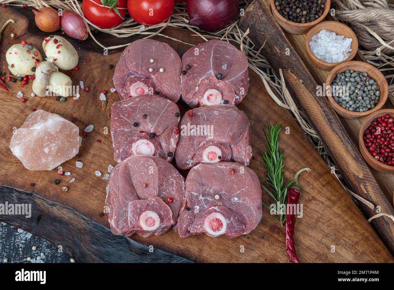 Raw lamb shanks meat, Raw lamb leg (Turkish name; kuzu incik). Fresh raw meat of leg young lamb. Raw lamb leg on marble stone background with herbs. Stock Photo