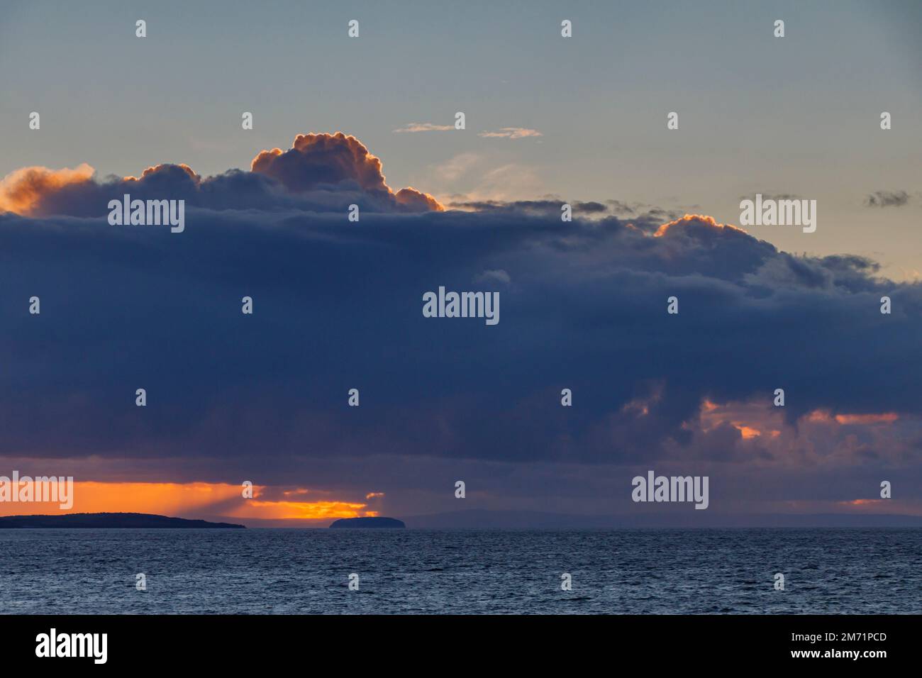 The setting sun light up the cloud cover Stock Photo Alamy