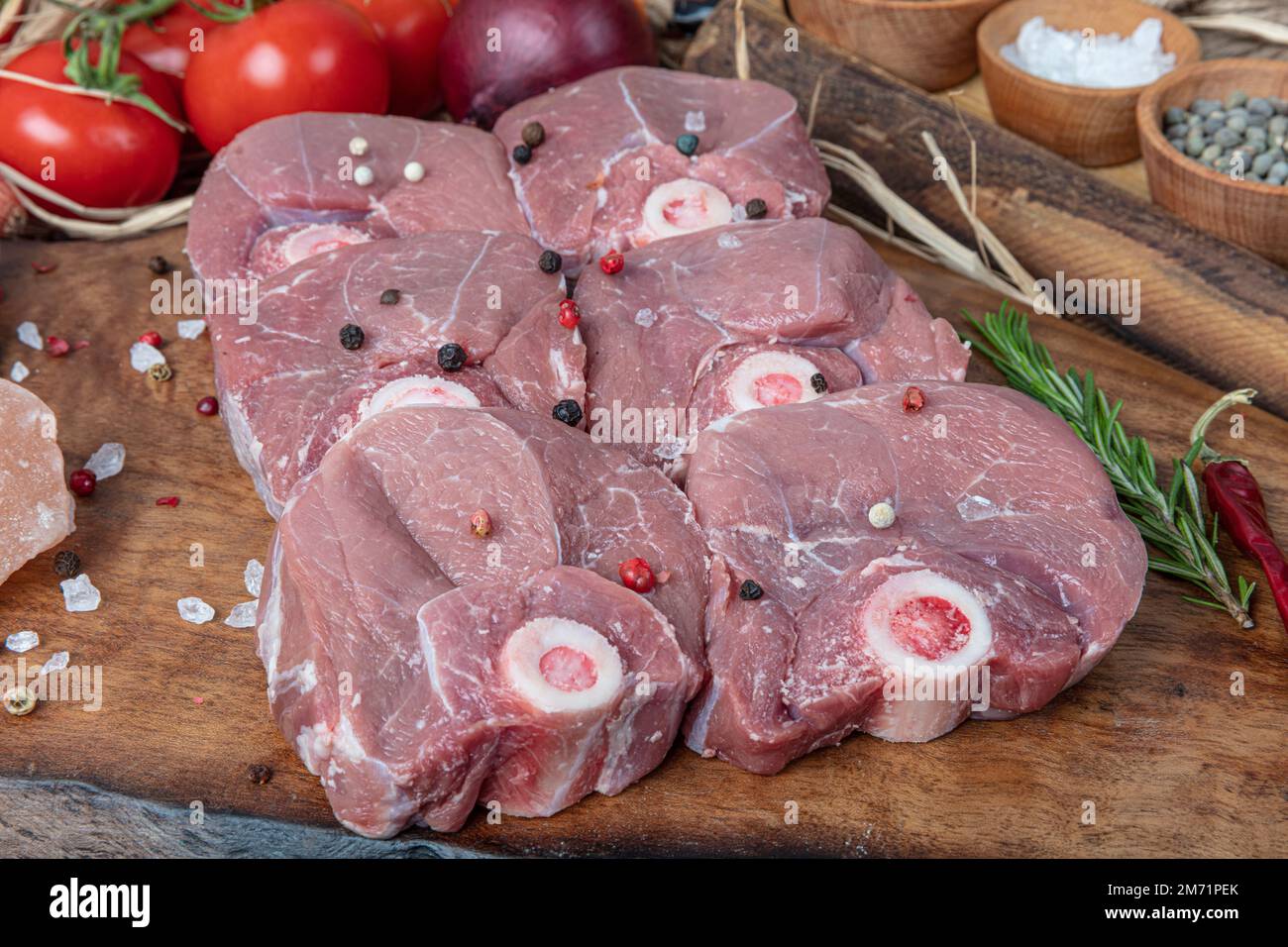 Raw lamb shanks meat, Raw lamb leg (Turkish name; kuzu incik). Fresh raw meat of leg young lamb. Raw lamb leg on marble stone background with herbs. Stock Photo