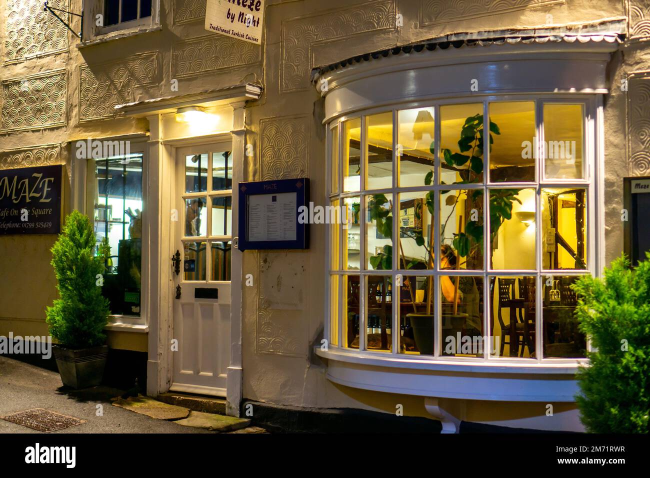 Coffee shop and restaurant lit up at night in Saffron Walden Stock Photo Alamy