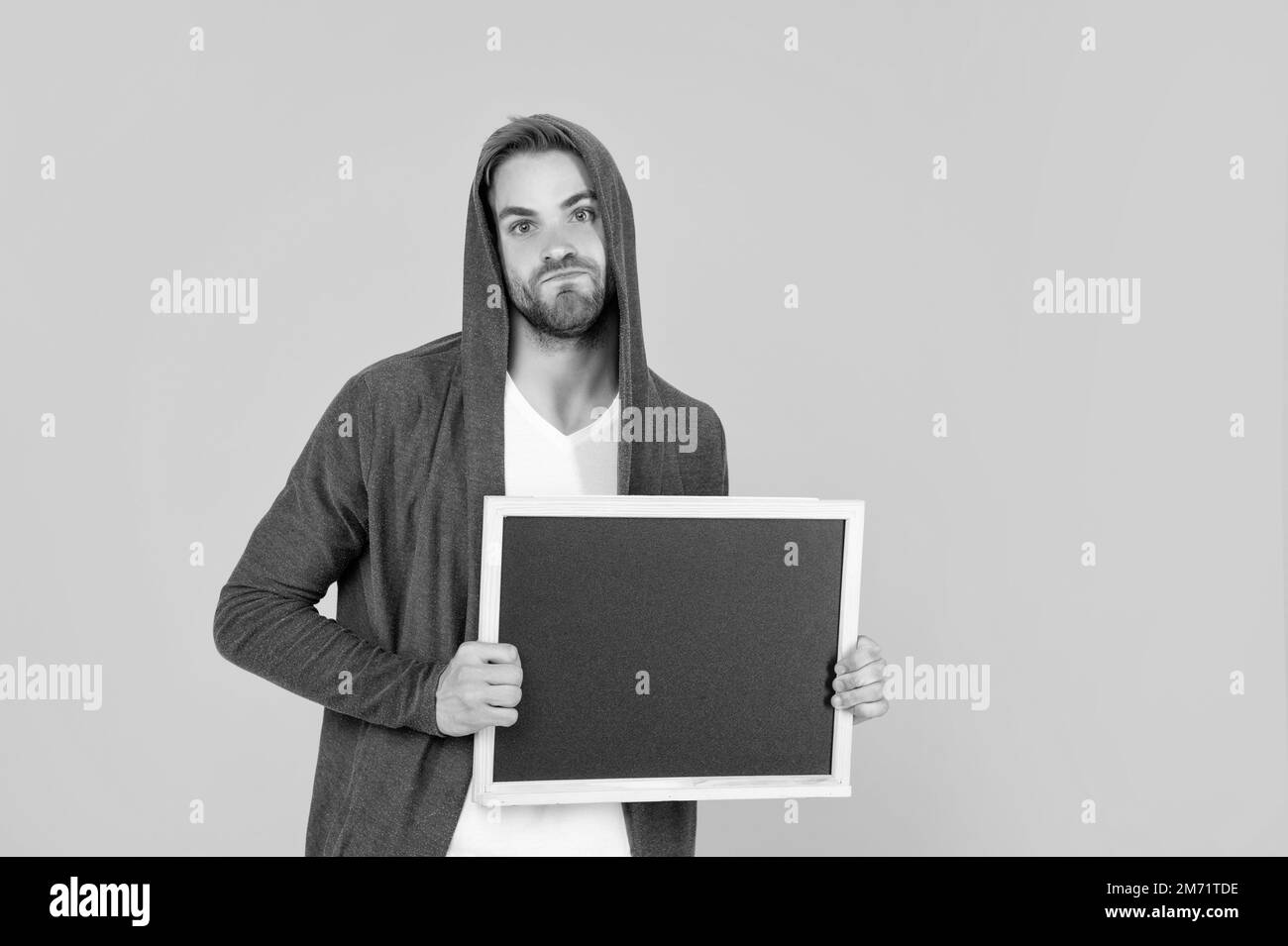 emotional man in hood with blackboard. guy make announcement Stock