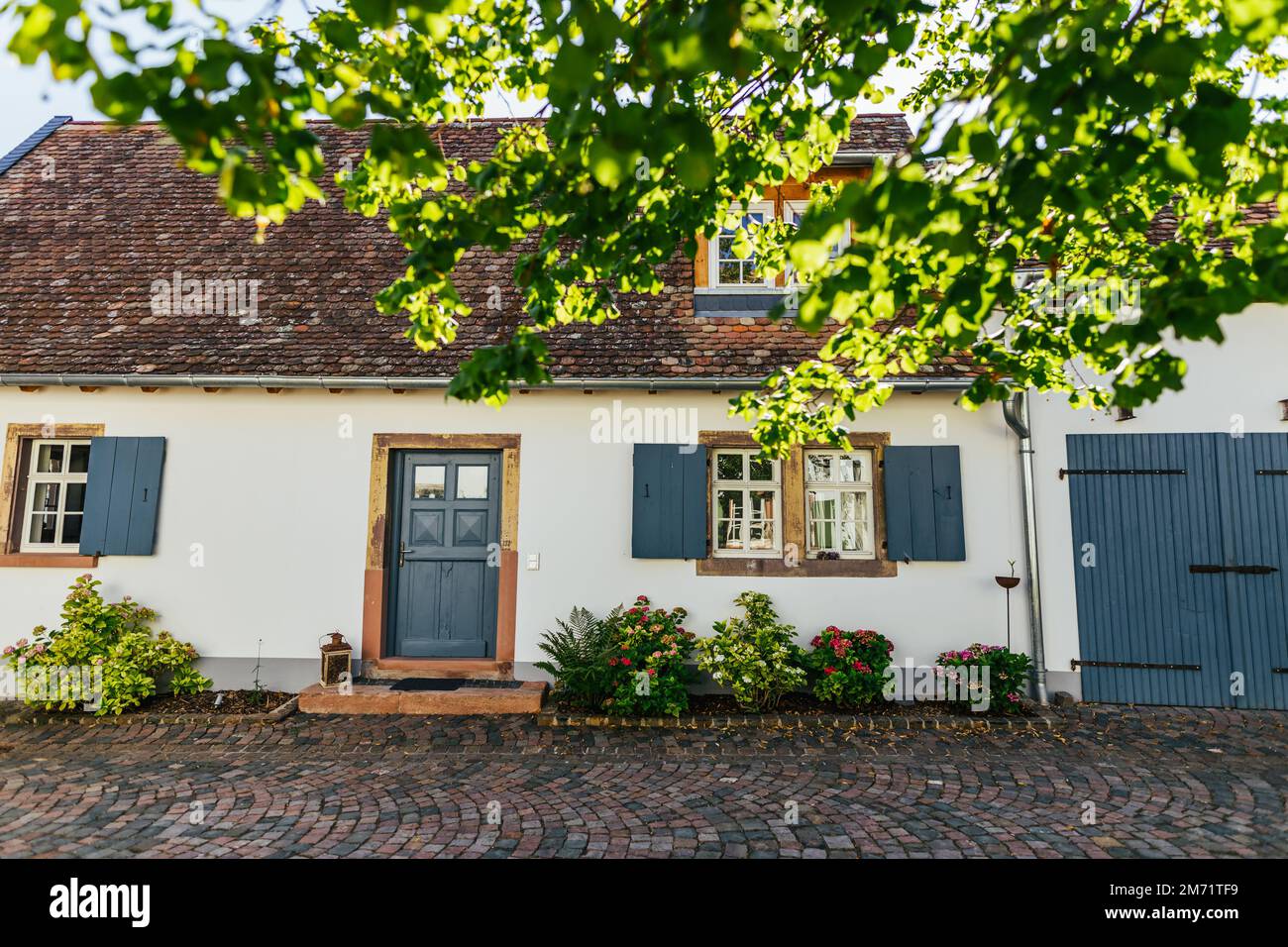 A beautiful white historic German house with blue doors and window
