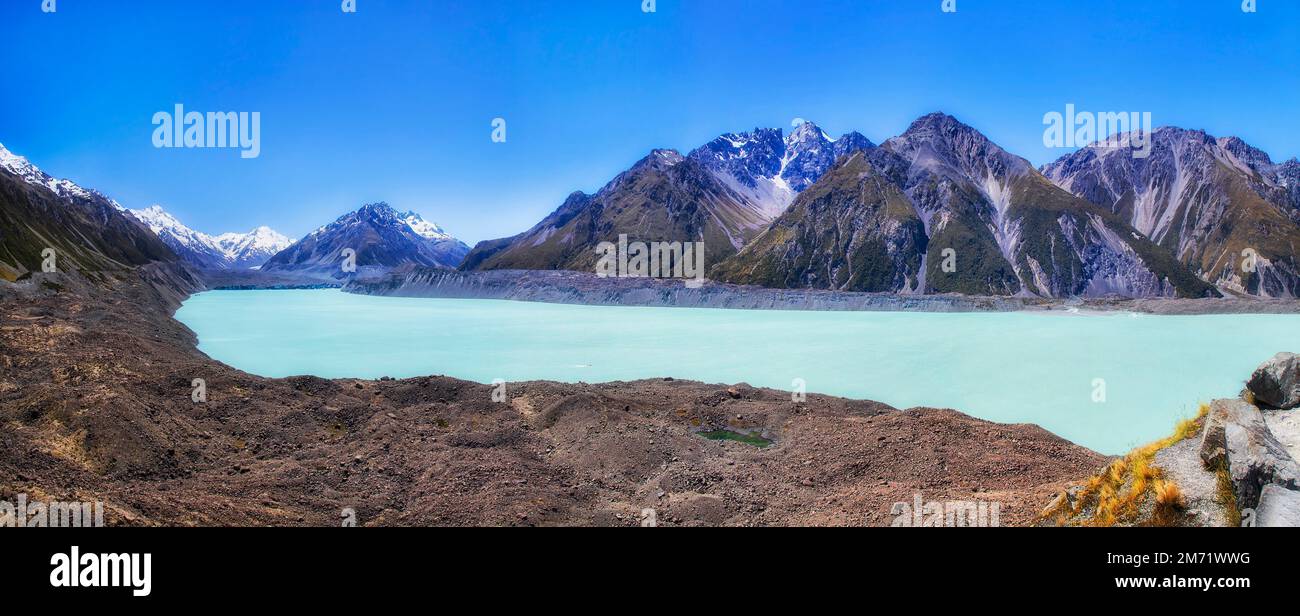 Wide scenic landscape panorama of Tasman lake at Tasman Glacier crawling from Mt Cook in New Zealand. Stock Photo