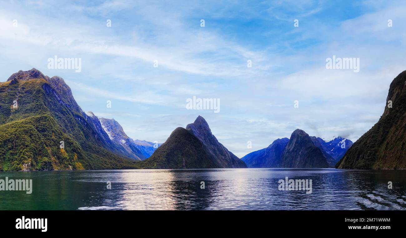 Scenic nature panorama of Milford Sound fiord mountain peaks with Mitre peak under blue sky. Stock Photo