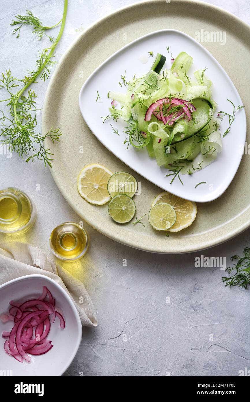 Cucumber salad with picled red onions and fresh coriander Stock Photo