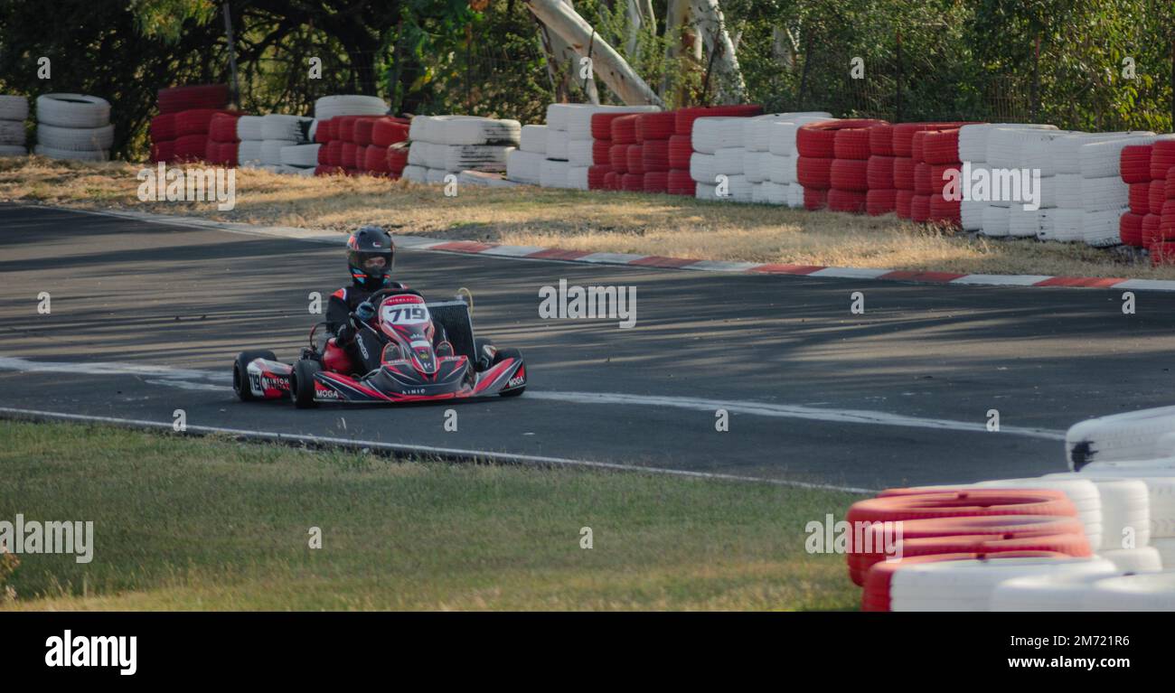 Queretaro, Queretaro, 11 18 22, boy in helmet and racing uniform, drives go kart on karting track, summer adrenaline sport Stock Photo