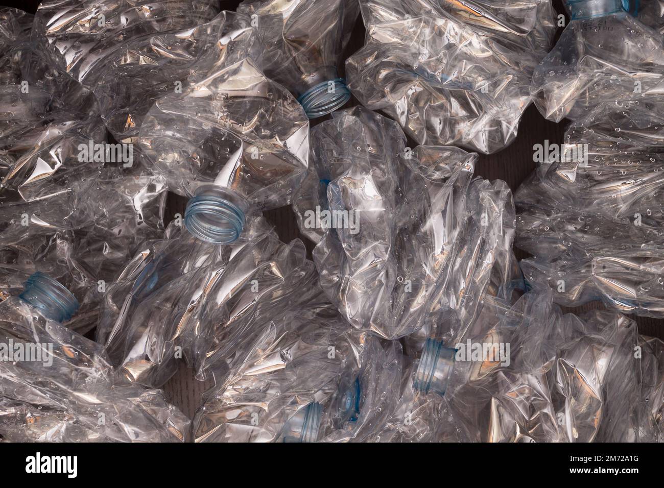 Plastic bottles background. Empty bottles on black surface. Non