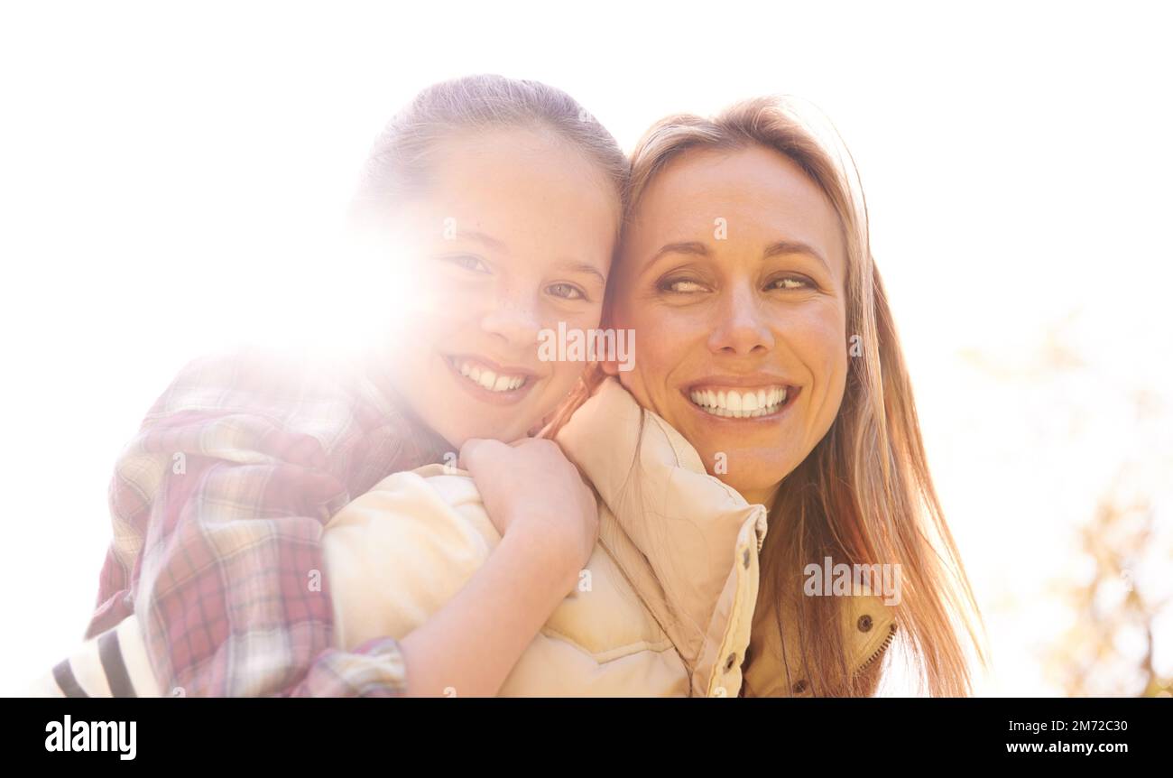 Fun in the sun with mom. A happy mother and daughter spending time together outdoors. Stock Photo