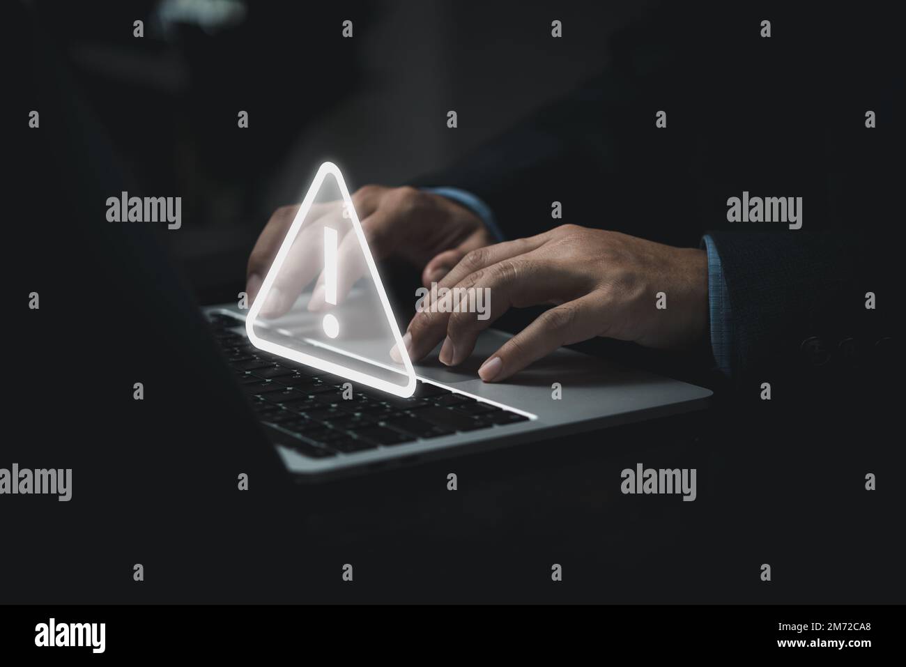 Businessman programmer, developer using laptop computer with triangle caution warning sign for notification error and maintenance concept. Stock Photo