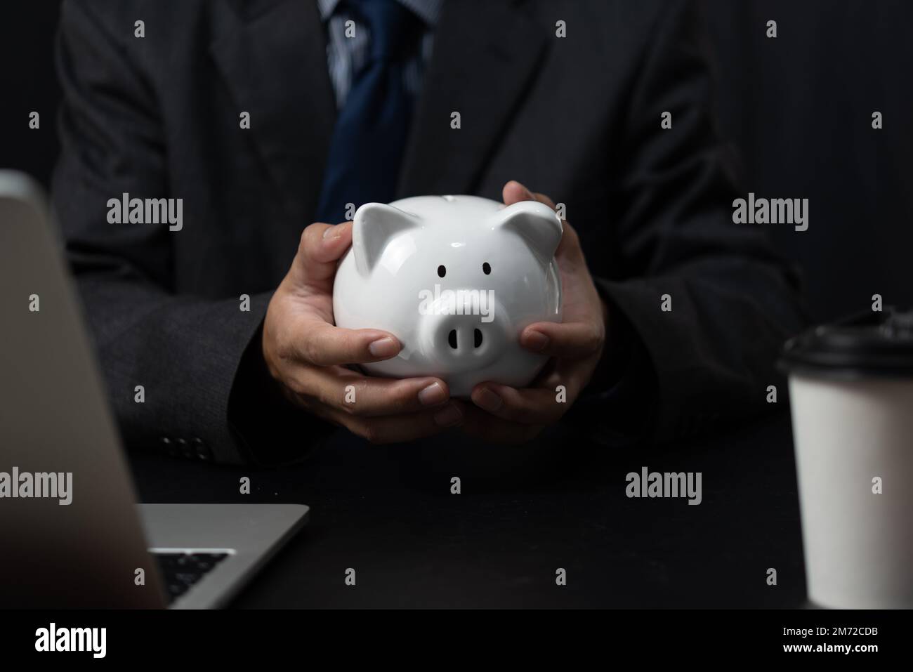 man holding a piggy bank white on hand.Saving money business investment finance Stock Photo