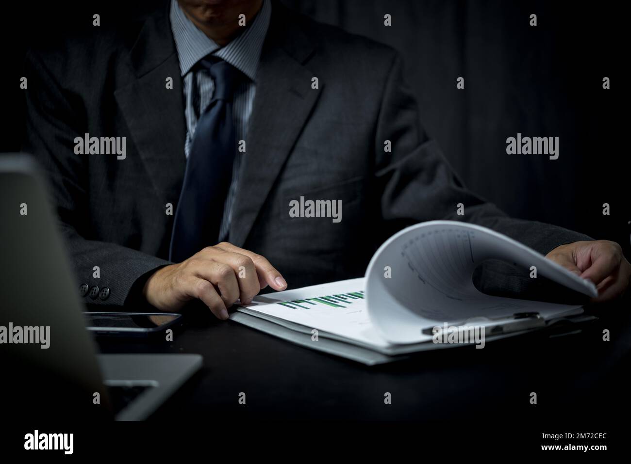 Businessman analyze marketing plan investment graph and financial chart growth management on desk. Stock Photo