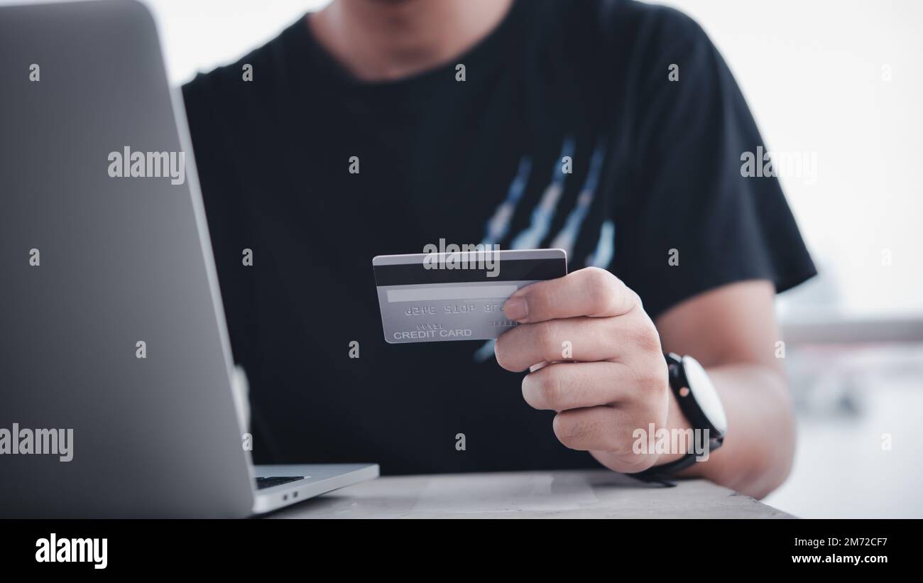 businessman using credit card and laptop to login to internet bank.Online shopping, e-commerce, internet banking, and financial transactions payments Stock Photo