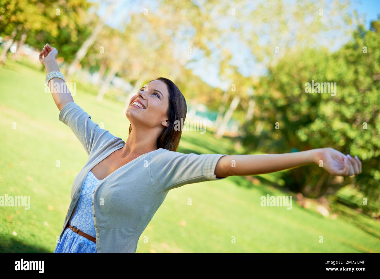 Feeling free. a carefree young woman enjoying a day at the park. Stock Photo