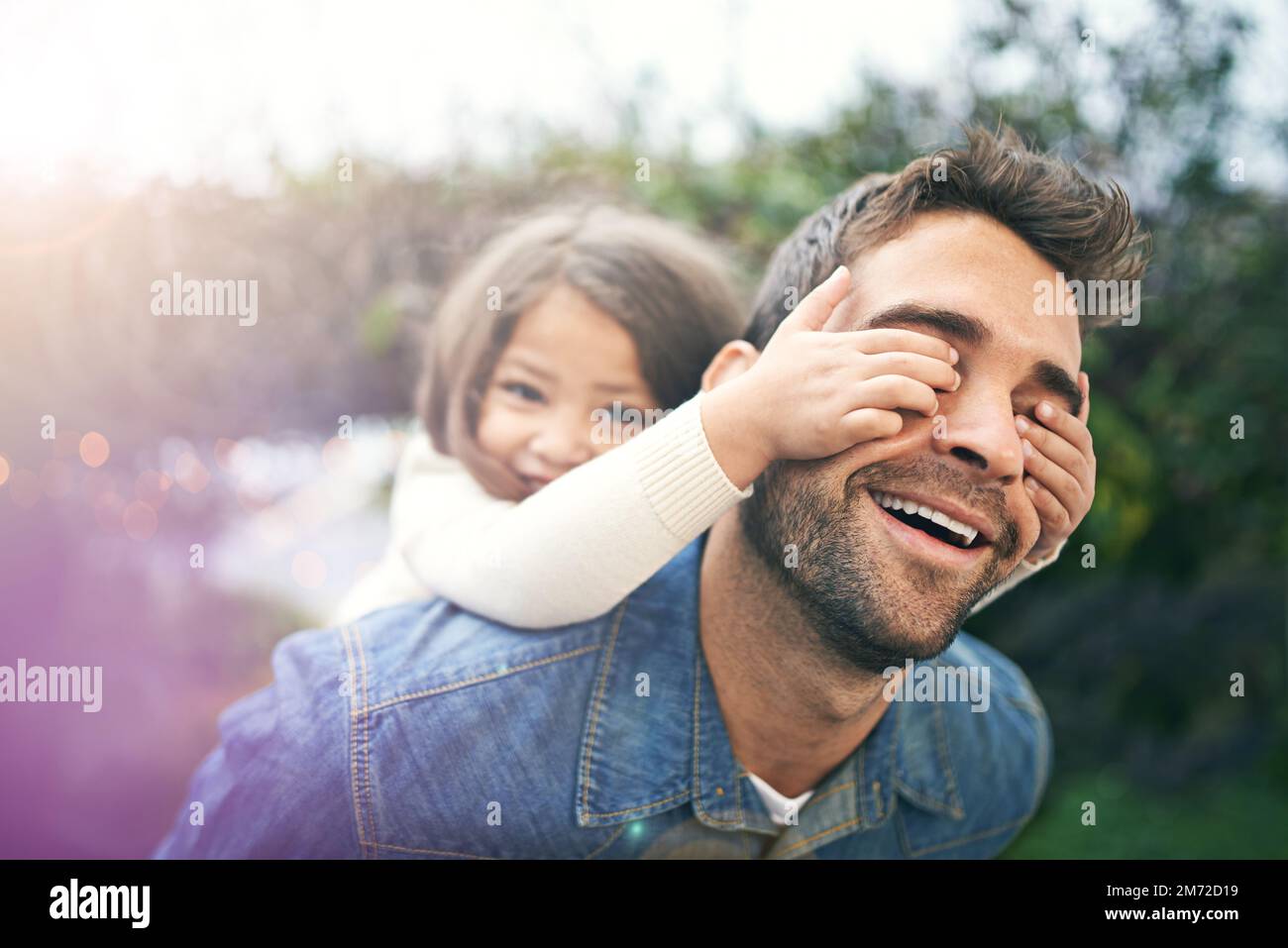 Enjoying a daddy daughter day. a little girl and her father playing together outdoors. Stock Photo