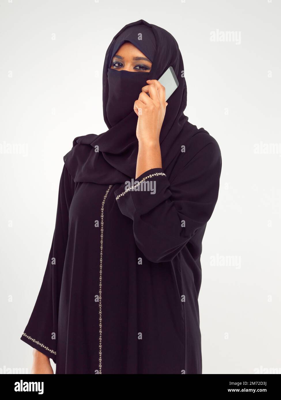 Modern meets tradition. Studio portrait of a young muslim woman talking ...