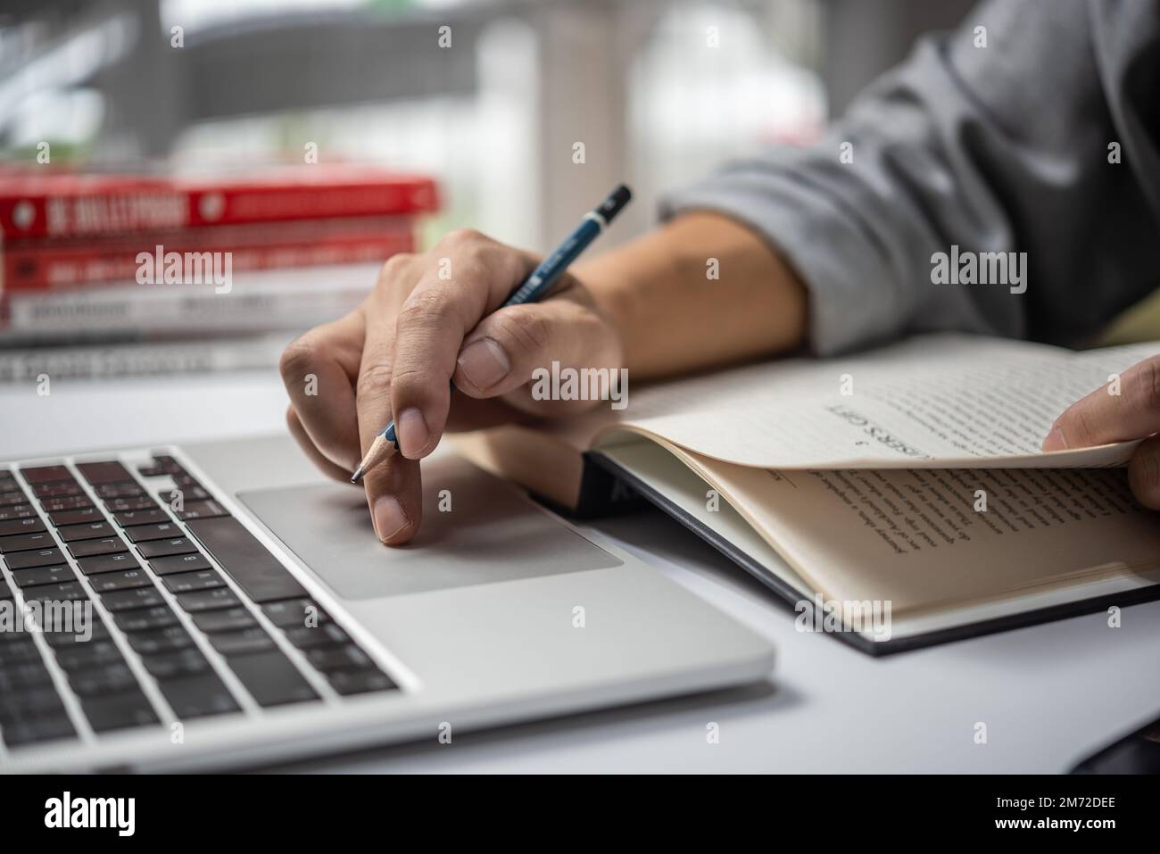 learning online class by using laptop computer and writing notebook at workplace, Education development or knowledge improvement concept. Stock Photo