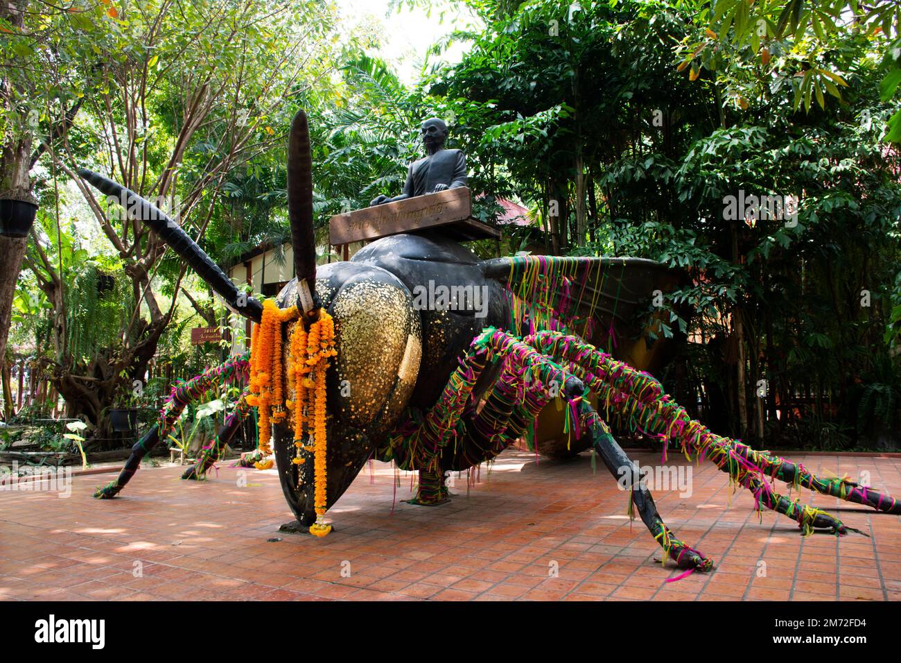 Reverend Luang Phor Kong sit on Giant large Phaya Hornet wasp in Khum Khun Phaen garden park in Wat Khae temple for thai people and foreign travelers Stock Photo