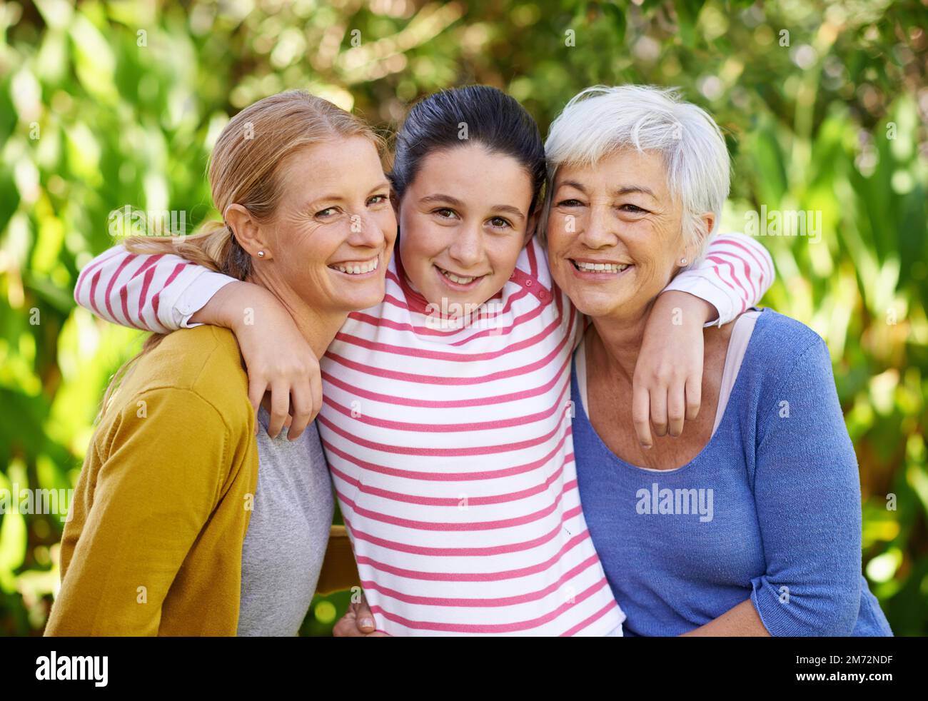 Were a close-knit family. three generations of family women standing outdoors. Stock Photo