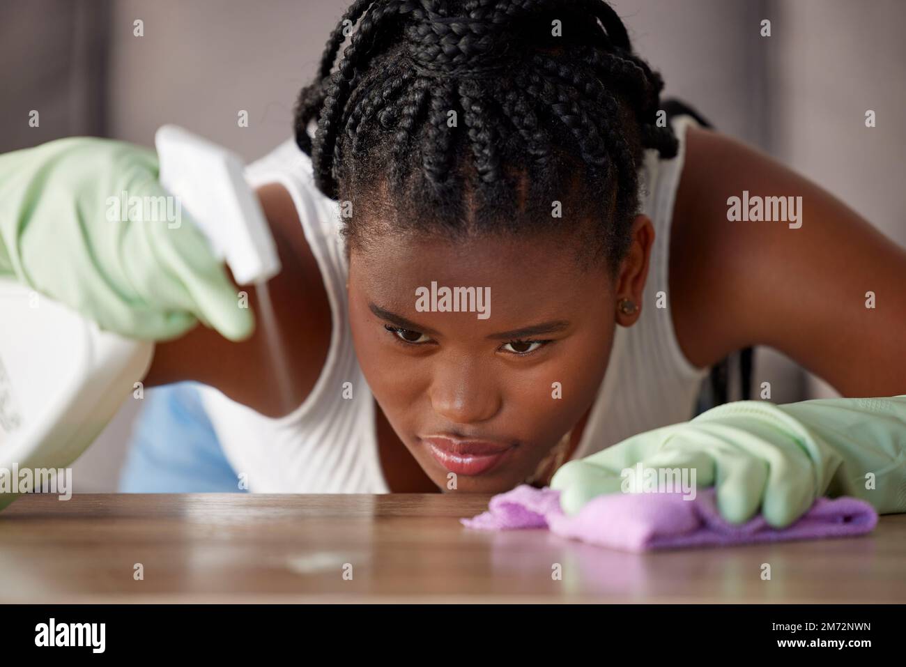 Cleaning, dust and black woman with spray on a table for furniture care