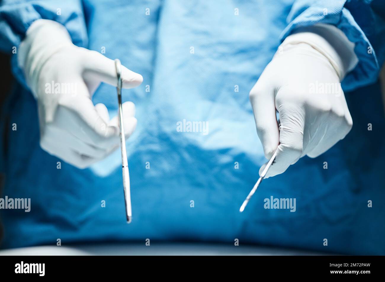 Doctor hands, gloves and surgery tools in closeup for healthcare, wellness or hospital job. Medic, health expert or professional with scissor, scalpel Stock Photo
