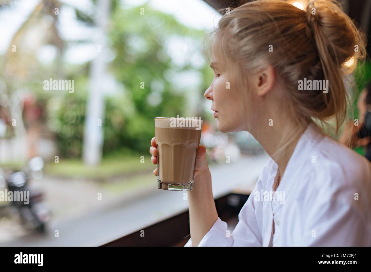 Girl drink latte coffee in street cafe in Bali Stock Photo Alamy