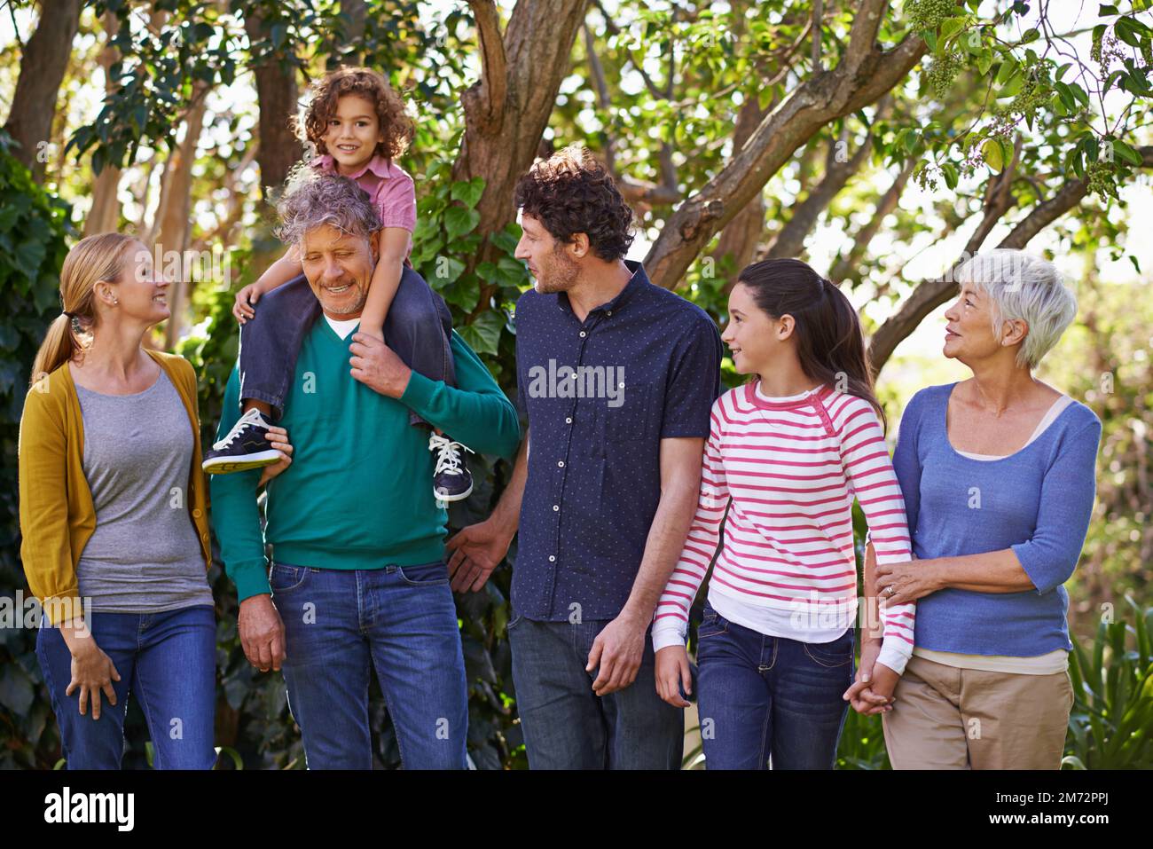 Making time for family. a happy family in their yard Stock Photo - Alamy