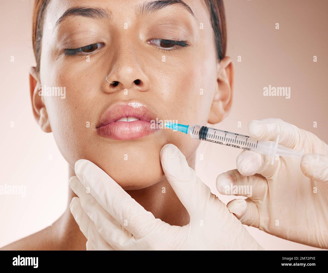 Botox, face and beauty with woman and lip filler, plastic surgery zoom and syringe needle for procedure. Hands, serum and cosmetic care for lips Stock Photo