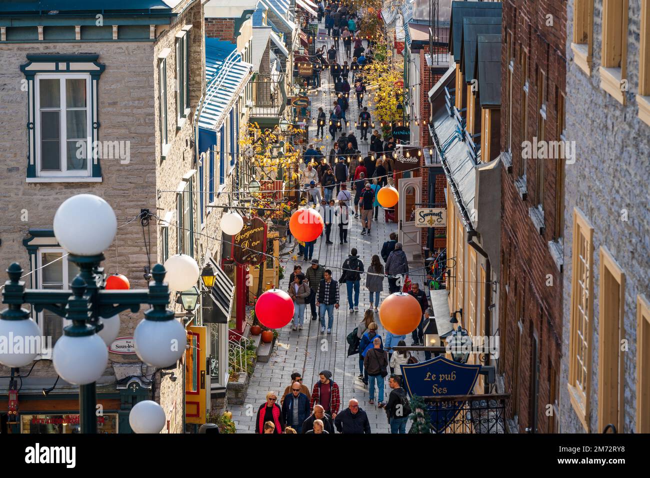 Quebec, Canada - October 23 2022 : Tourists shopping on the Quartier du Petit Champlain street. Quebec City Old Town in autumn. Stock Photo