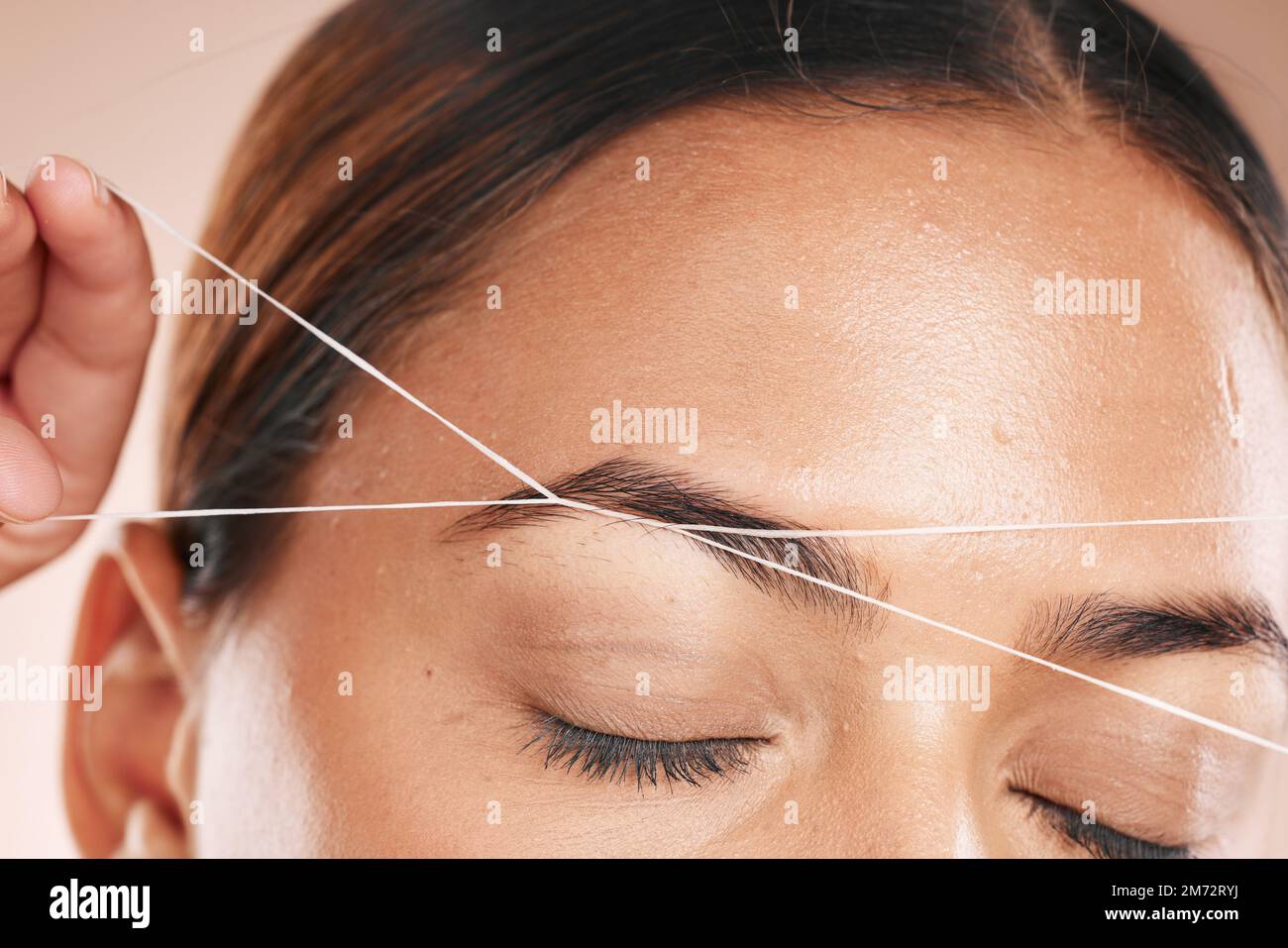 Eyebrows, grooming and woman threading hair on face for beauty routine