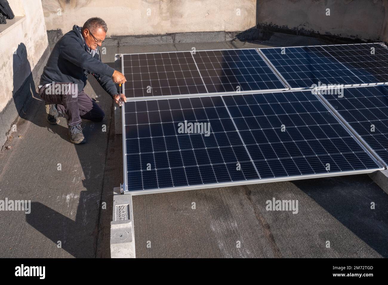 Installation of solar panels for the production of electricity on a house terrace. Abruzzo, Italy, Europe Stock Photo