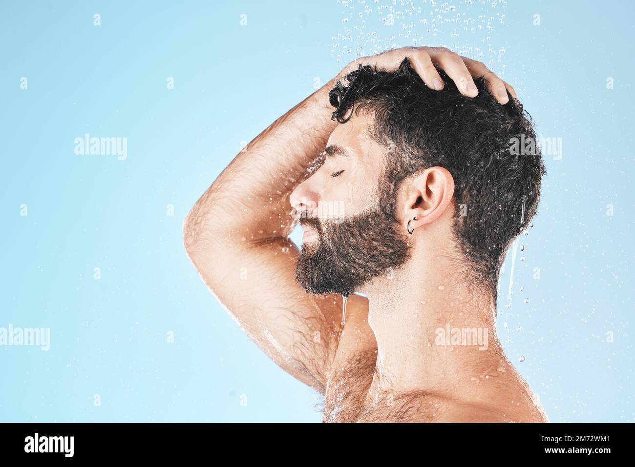 Hair care shower, face and water splash of man in studio isolated on a ...